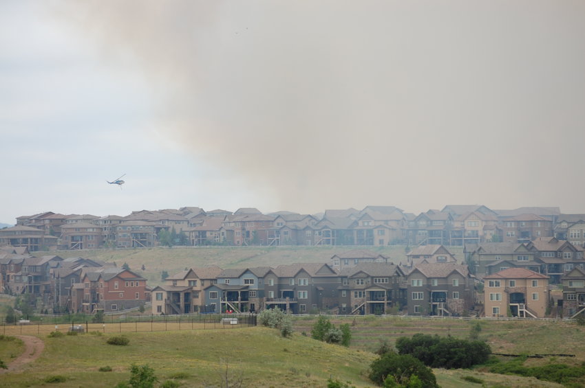 Smoke billows above homes in the BackCountry neighborhood of Highlands Ranch at about 2 p.m. June 29, 2020, as firefighters worked to contain the 267-acre blaze that forced mandatory evacuations from the subdivision. Haze from the wildfire spread throughout the area near Wildcat Reserve Parkway and Gateway Drive, near the subdivision's entrance.